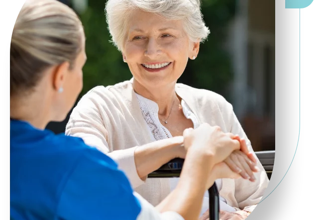 A woman and a nurse are holding hands.