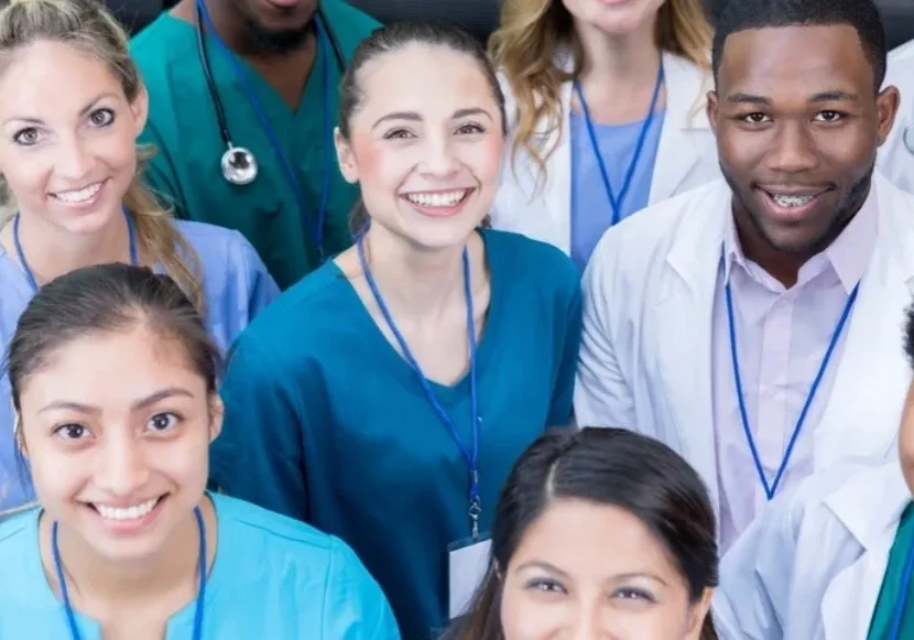 A group of doctors and nurses are smiling for the camera for home health care services